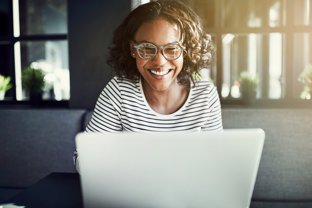 happy woman working on laptop