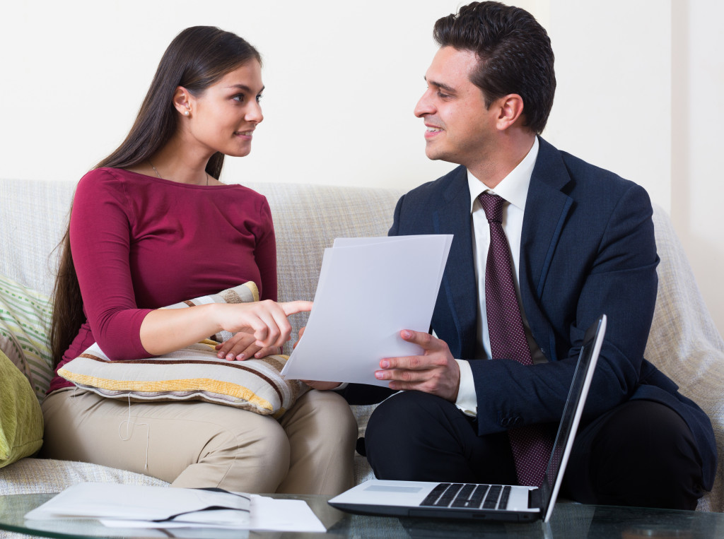 a woman pointing at a document while talking to a family lawyer