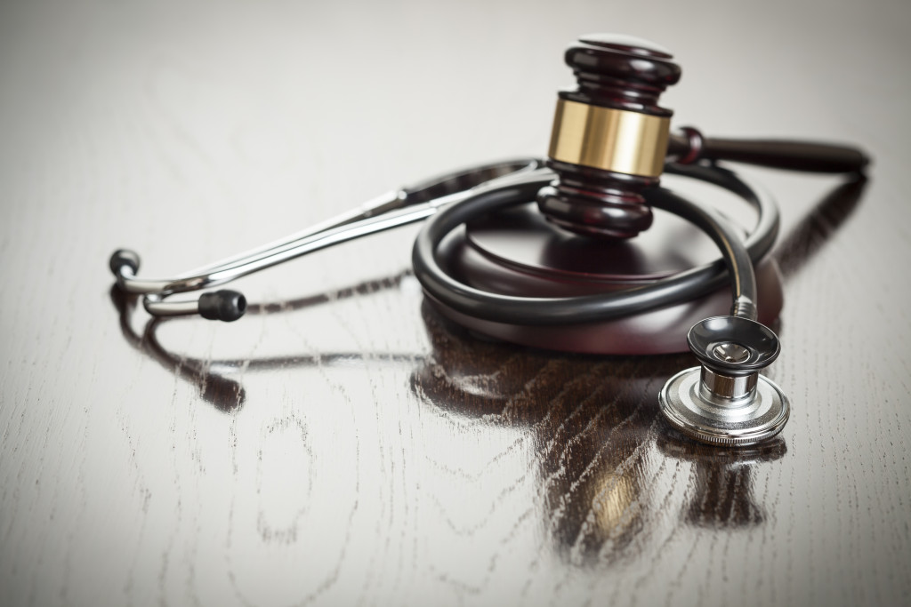 gravel and stethoscope on wooden table