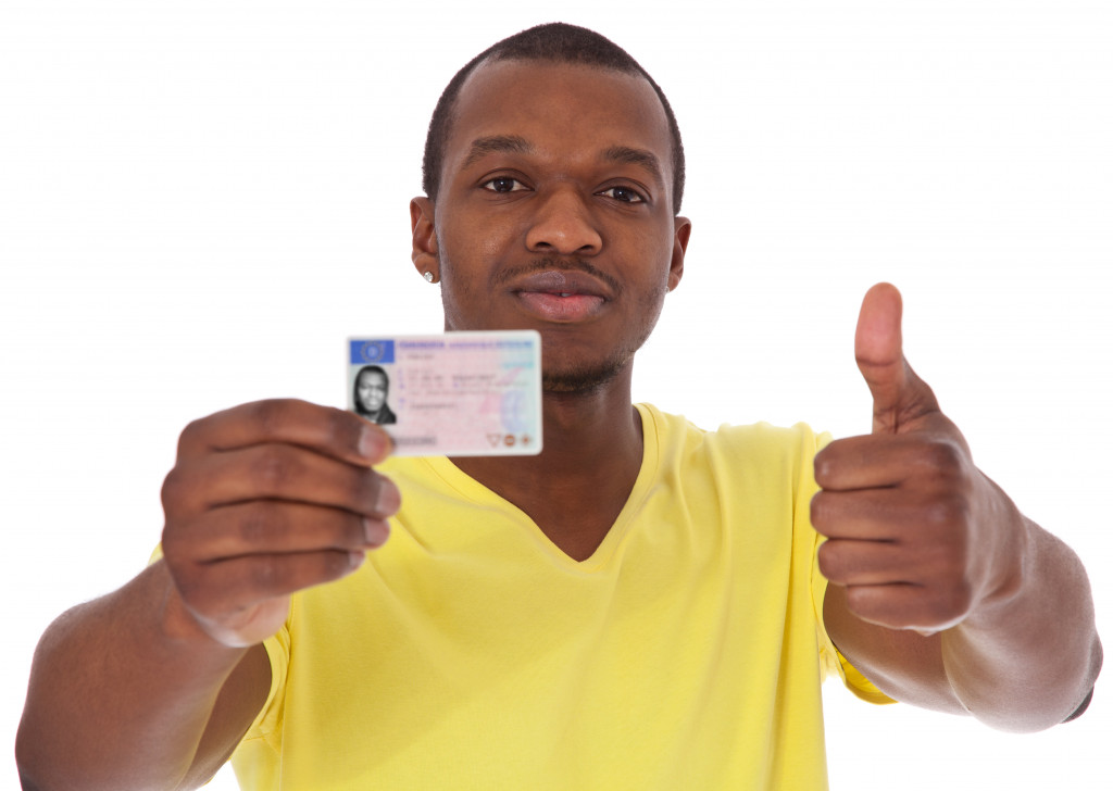 A driver is seen displaying his license.