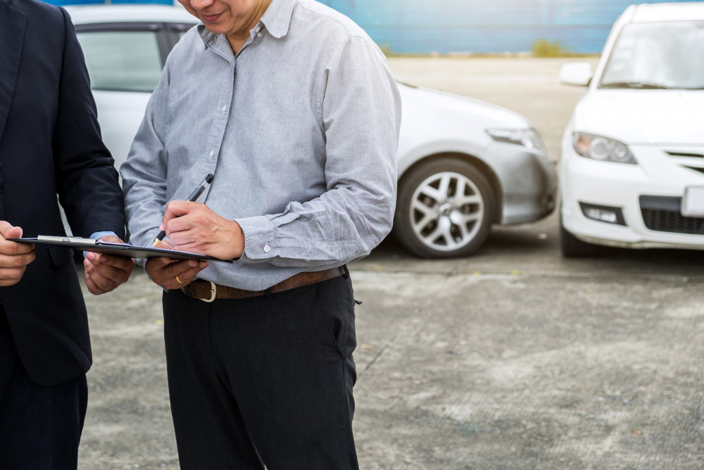 man examining damaged client possible accident