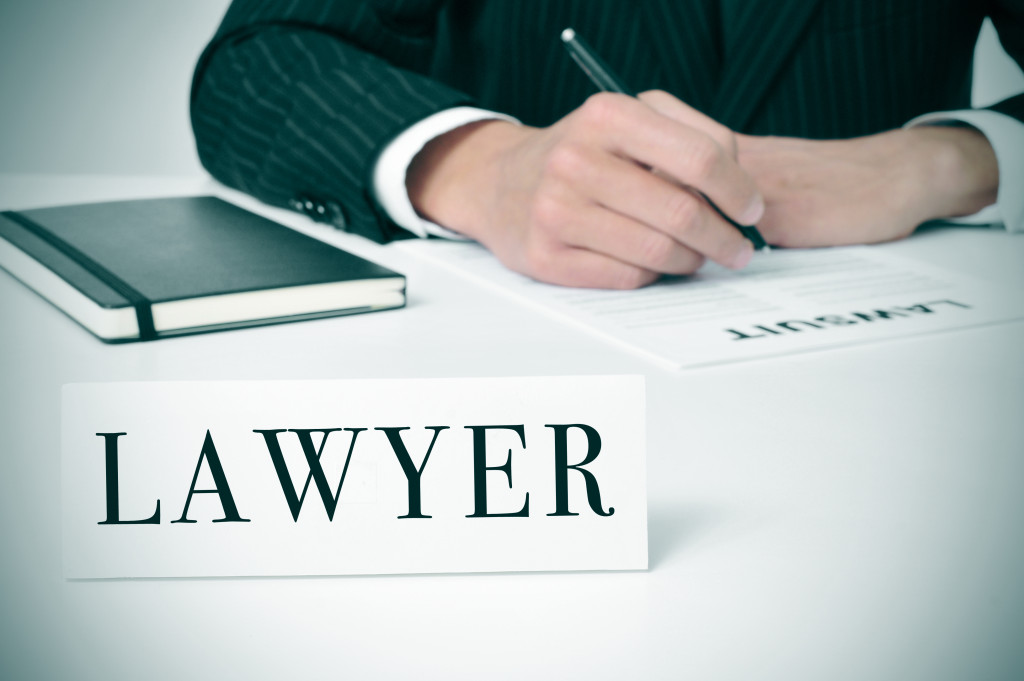 LAWYER sign in front of a man behind a desk