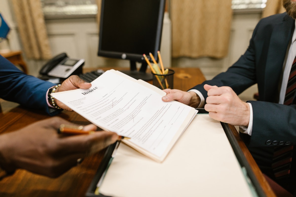 a person handing over a divorce paper