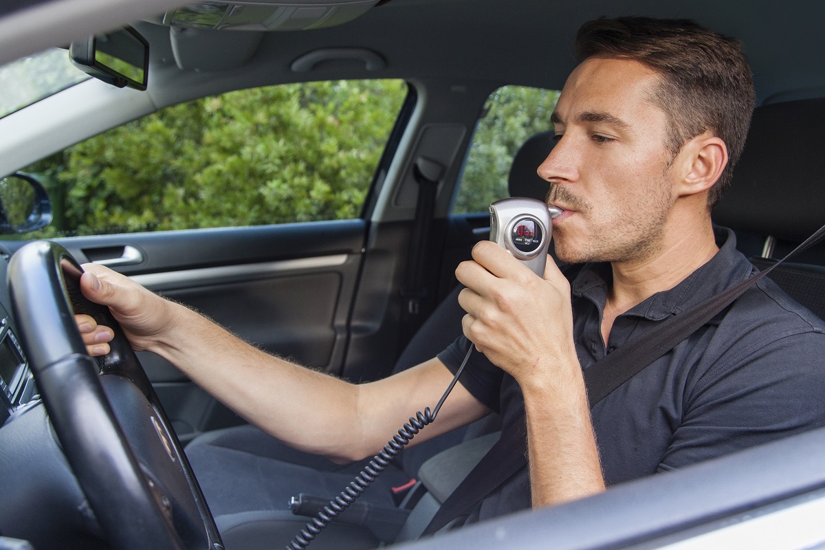 A man using a breath analyzer