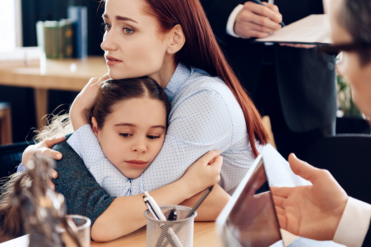 a woman hugging a child