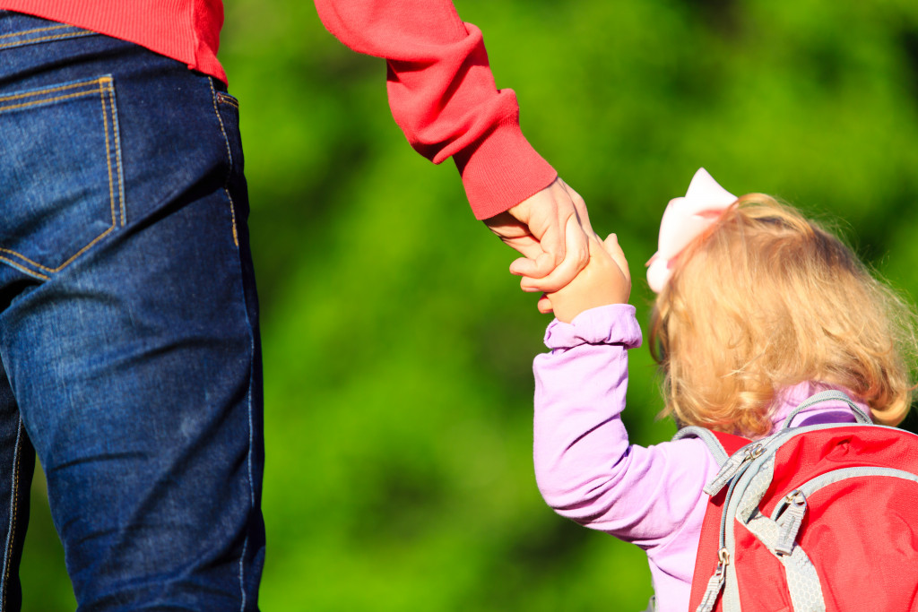 co parenting and a mother taking her daughter to school