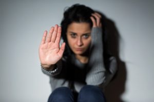 domestic violence victim woman signalling stop