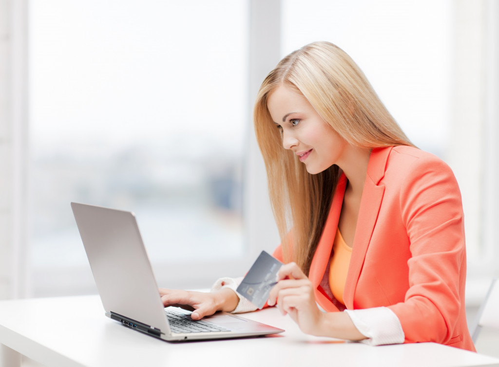 Young woman checking her finances on a laptop.